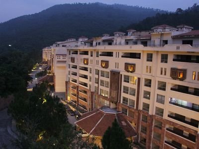 Country Club Apartments illuminated at twilight, Murree