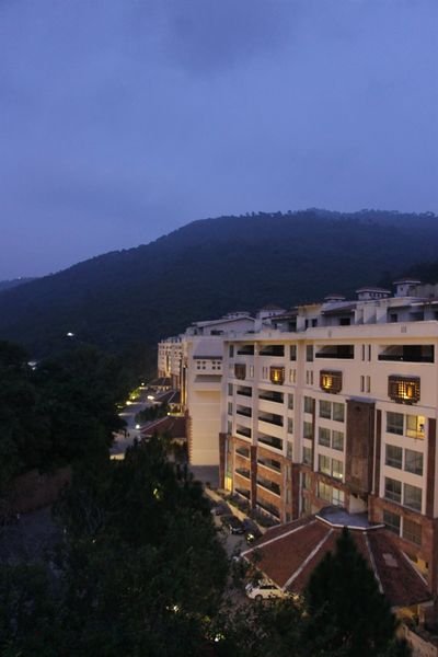 Country Club Apartments against the hills at dusk, Murree